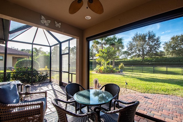 view of patio featuring glass enclosure and ceiling fan