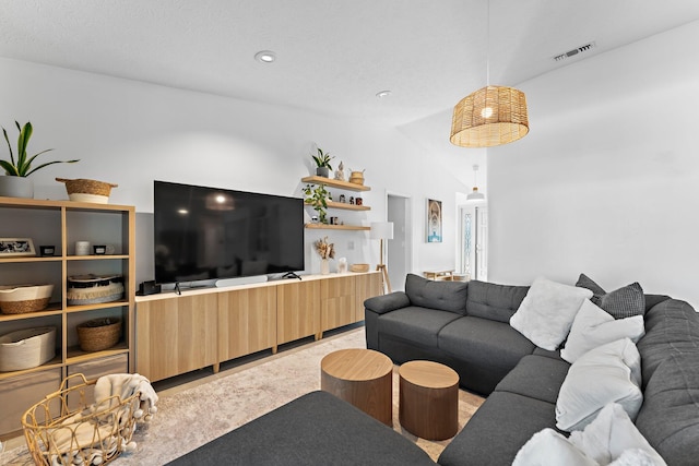 living room with vaulted ceiling, light carpet, and visible vents