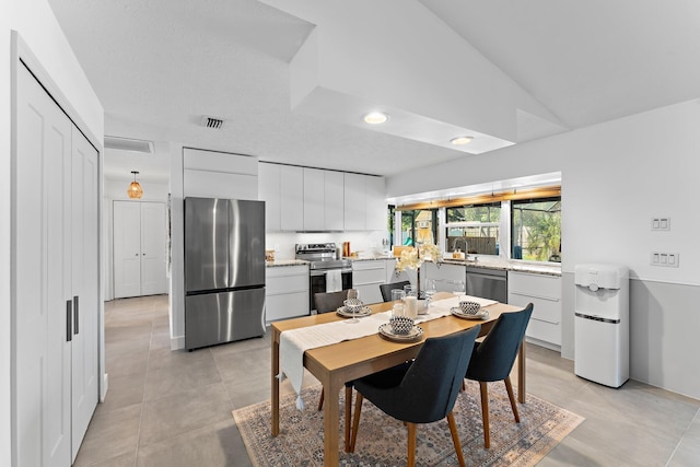 dining area with lofted ceiling, light tile patterned floors, visible vents, and recessed lighting