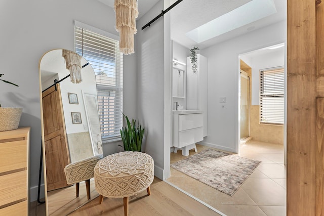 bathroom featuring a shower, tile patterned flooring, and baseboards