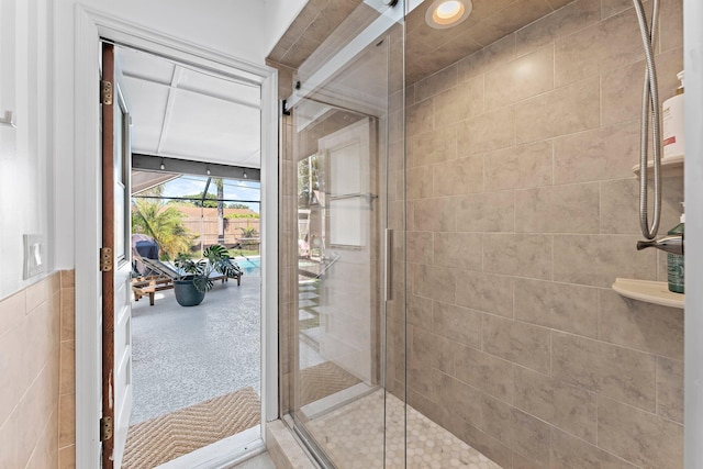 bathroom featuring a stall shower and tile walls