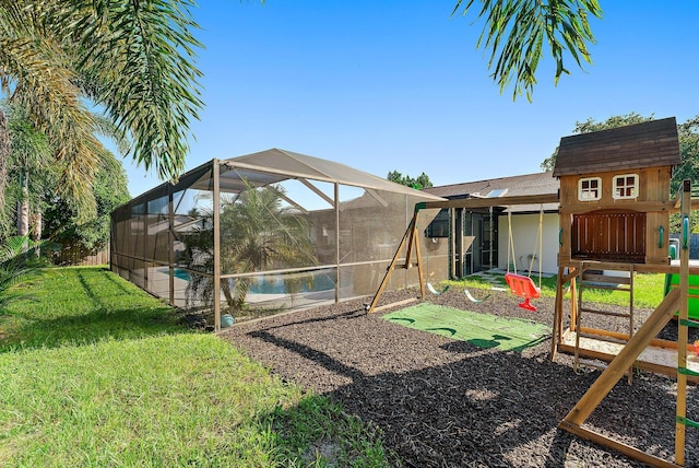 view of yard featuring glass enclosure, a playground, and an outdoor pool