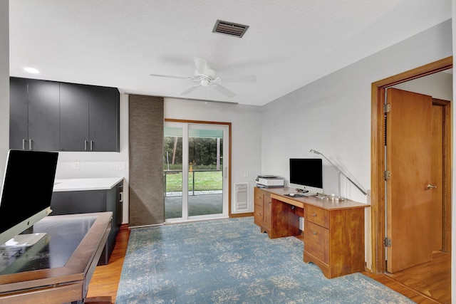 office space with ceiling fan and light hardwood / wood-style floors