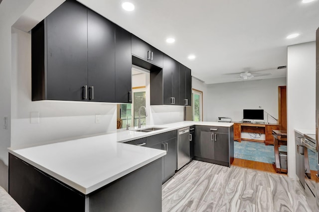 kitchen featuring ceiling fan, stainless steel dishwasher, kitchen peninsula, sink, and light hardwood / wood-style flooring