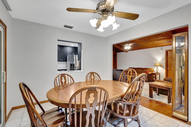 dining space with ceiling fan and light tile patterned floors