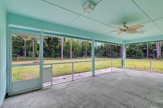 unfurnished sunroom with ceiling fan