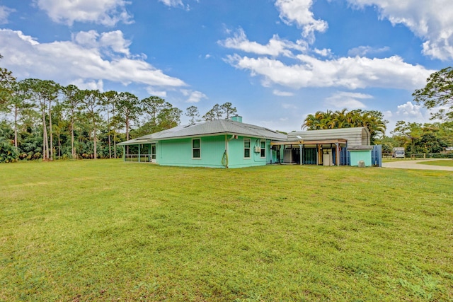 rear view of property with a lawn