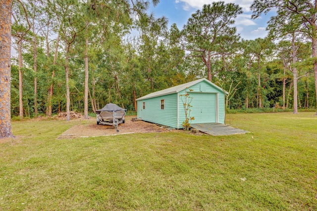 view of yard with a garage and an outdoor structure