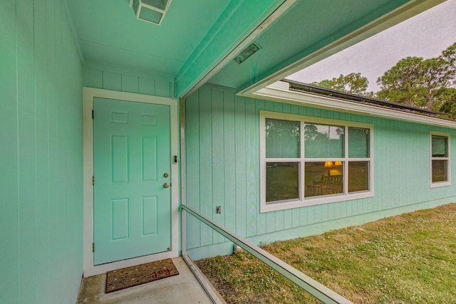 doorway to property with a yard