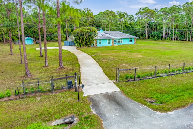 exterior space with a front lawn and solar panels