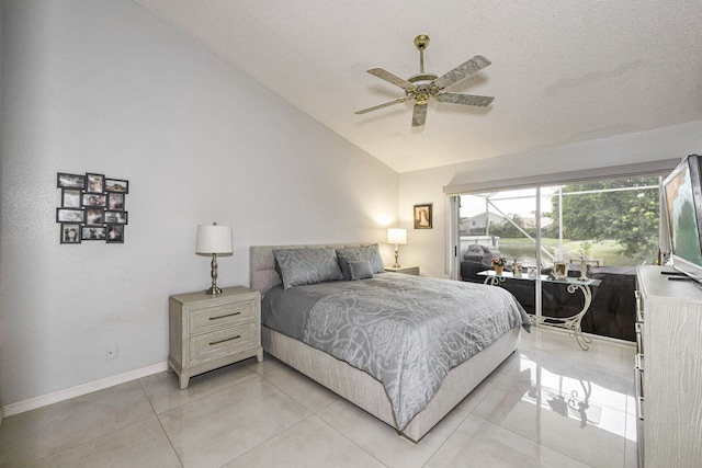 bedroom featuring ceiling fan, a textured ceiling, light tile patterned floors, and lofted ceiling