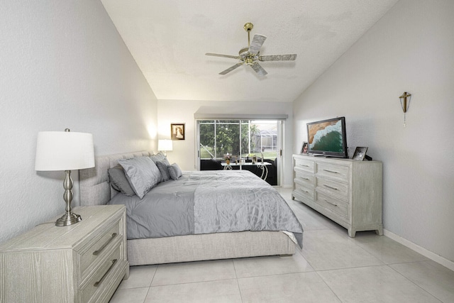 bedroom featuring ceiling fan, a textured ceiling, light tile patterned floors, and lofted ceiling