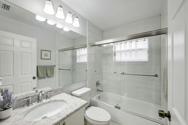 full bathroom with shower / bath combination with glass door, toilet, and vanity