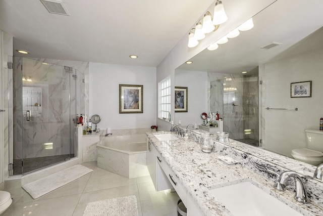 full bathroom with tile patterned floors, toilet, vanity, and separate shower and tub