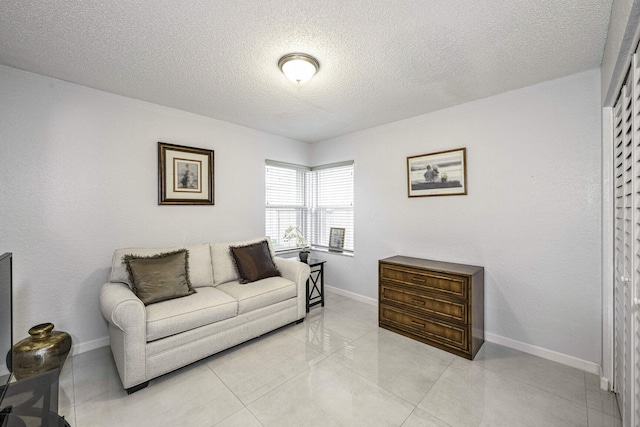 living room featuring light tile patterned floors and a textured ceiling