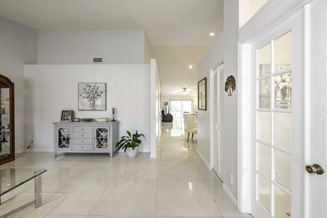 hallway featuring a high ceiling