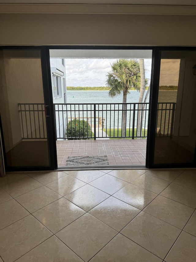 doorway to outside featuring tile patterned flooring and a water view