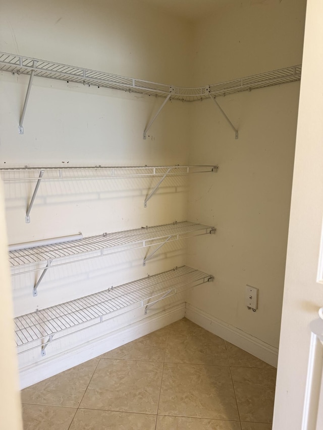 spacious closet featuring tile patterned flooring