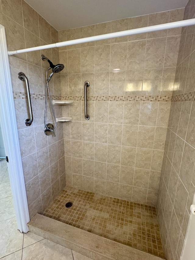 bathroom featuring tiled shower and tile patterned floors