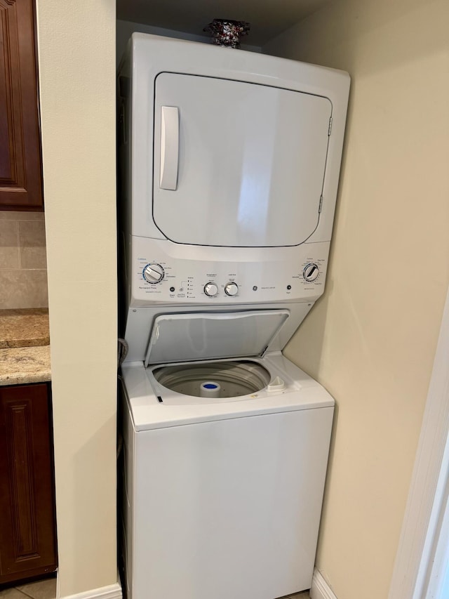 washroom with stacked washer and clothes dryer