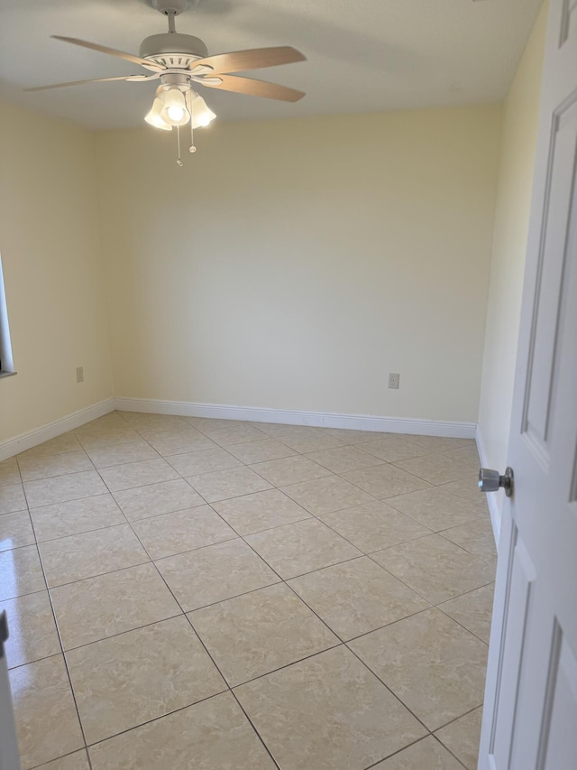 empty room with light tile patterned floors and ceiling fan