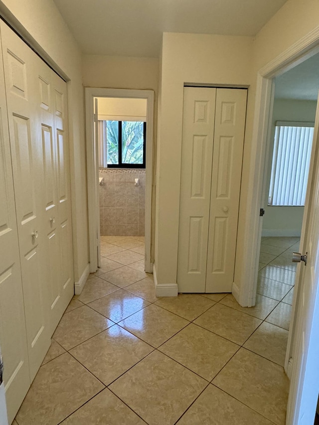 hallway featuring light tile patterned floors