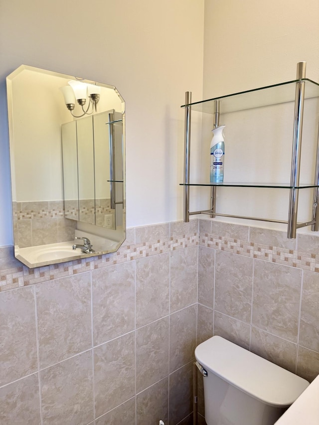 bathroom with toilet and tile walls