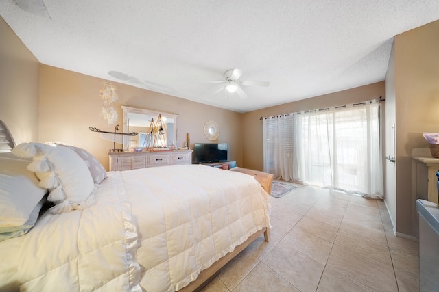 tiled bedroom featuring a textured ceiling and ceiling fan