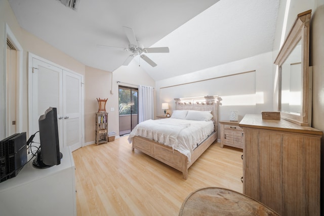 bedroom featuring ceiling fan, light hardwood / wood-style floors, and lofted ceiling