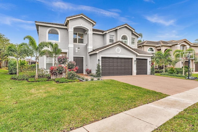 mediterranean / spanish-style home with a garage and a front lawn