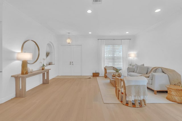 living room featuring ornamental molding and light hardwood / wood-style floors