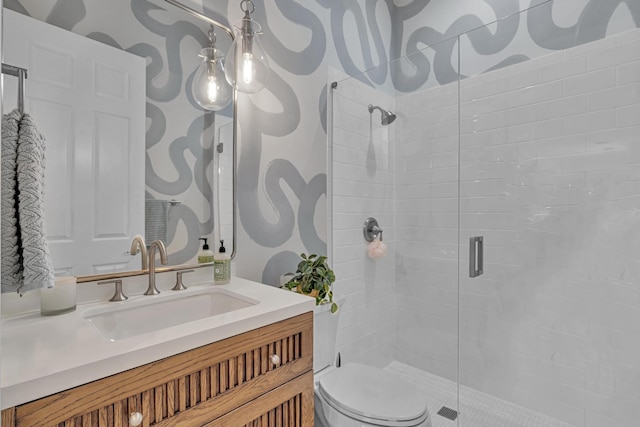 bathroom with an enclosed shower, vanity, and toilet