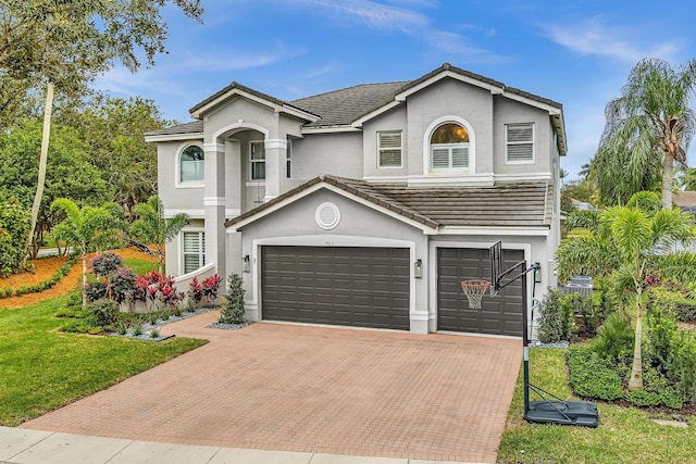 view of front of home featuring a garage and a front yard