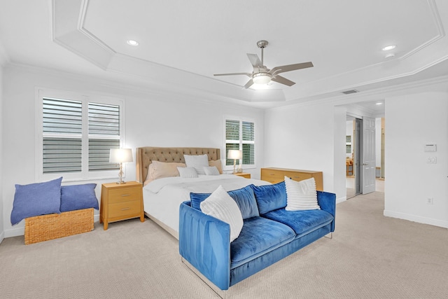 bedroom with crown molding, light carpet, ceiling fan, and a tray ceiling