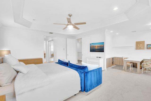 bedroom featuring ornamental molding, light colored carpet, ceiling fan, and a tray ceiling