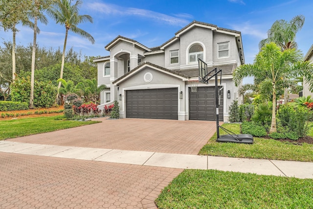 view of front of home featuring a garage and a front lawn