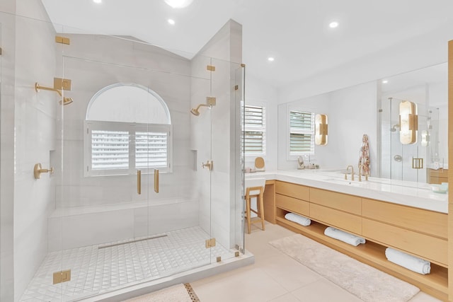 bathroom featuring vanity, an enclosed shower, tile patterned flooring, and a wealth of natural light