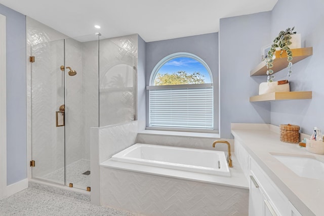 bathroom featuring tile patterned floors, vanity, and shower with separate bathtub