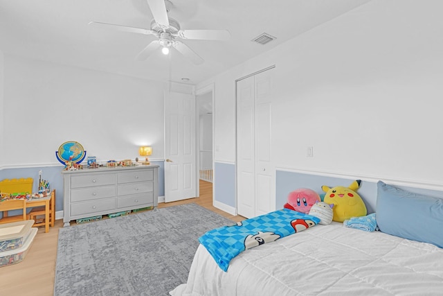 bedroom featuring a closet, ceiling fan, and light wood-type flooring