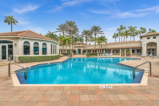 view of pool featuring french doors and a patio