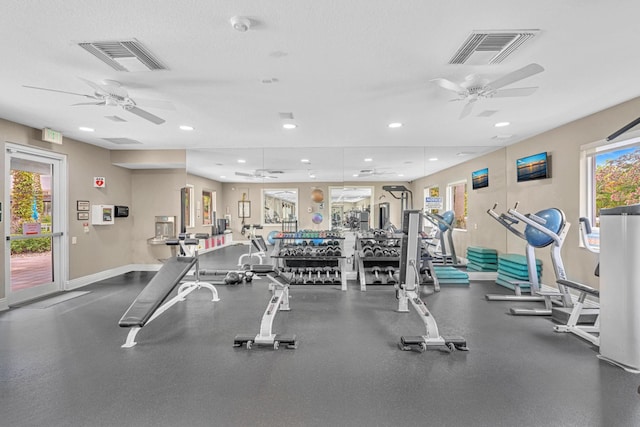 workout area featuring ceiling fan and a textured ceiling