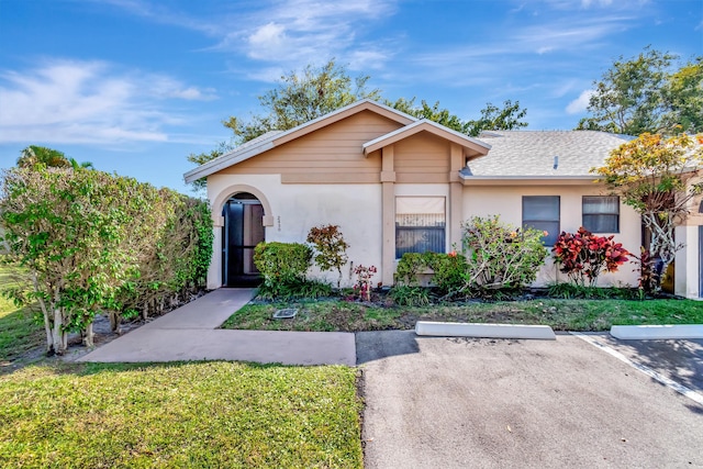 ranch-style home with a front yard