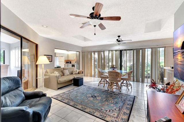 tiled living room featuring a textured ceiling