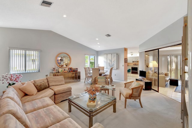 carpeted living room featuring vaulted ceiling