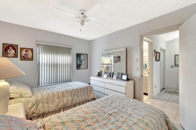 bedroom with ceiling fan, ensuite bath, a textured ceiling, and light tile patterned floors