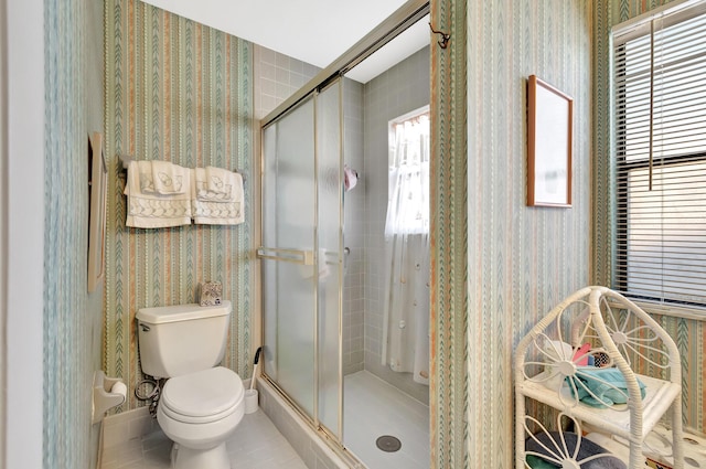 2430 NW 12th St, Delray Beach, FL 33445 - bathroom with wallpapered walls, toilet, a shower stall, and tile patterned floors