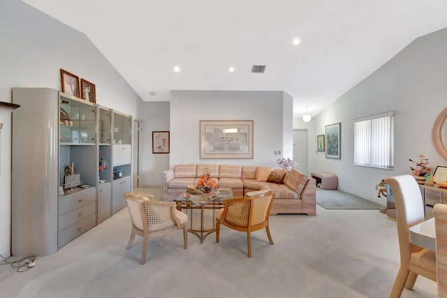 living room featuring light carpet and vaulted ceiling