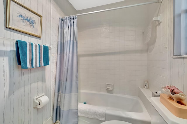 bathroom with toilet and shower / bath combo with shower curtain