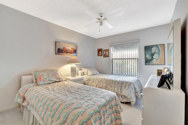 bedroom with ceiling fan, light colored carpet, and a textured ceiling