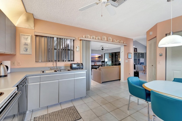 kitchen with sink, gray cabinetry, hanging light fixtures, light tile patterned floors, and ceiling fan